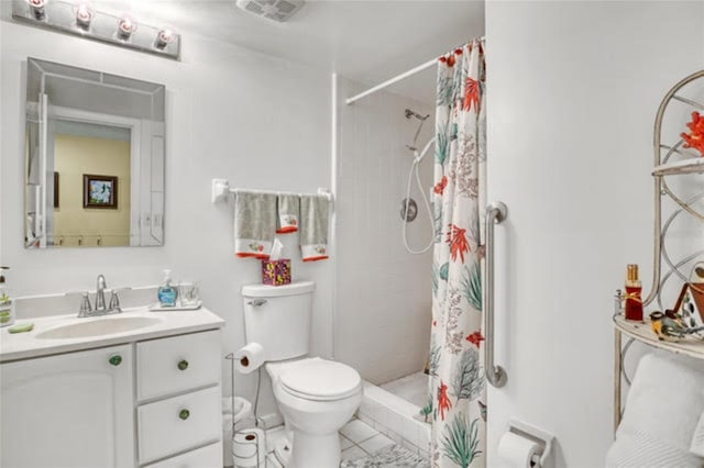 bathroom with toilet, tiled shower, visible vents, tile patterned flooring, and vanity