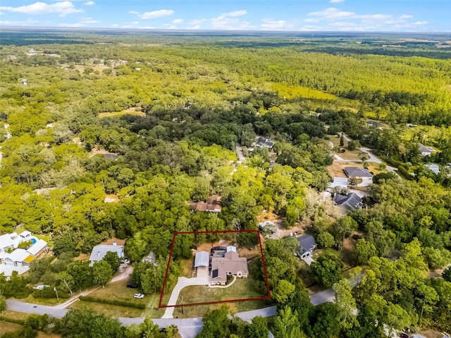 drone / aerial view featuring a view of trees