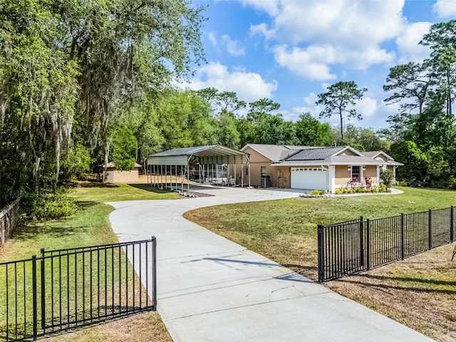 view of front of home featuring concrete driveway, a front lawn, a carport, fence private yard, and stucco siding