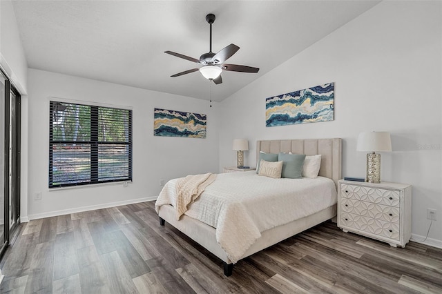bedroom with baseboards, vaulted ceiling, wood finished floors, and ceiling fan