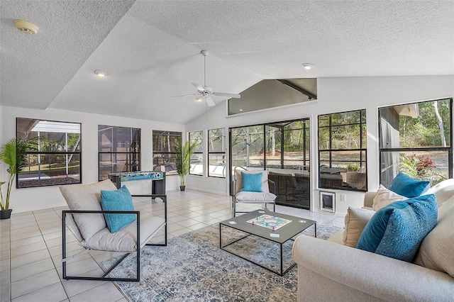 sunroom / solarium featuring high vaulted ceiling, baseboards, tile patterned flooring, and a textured ceiling