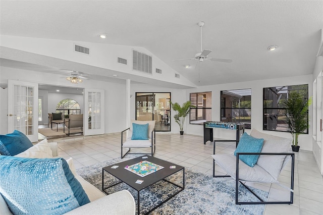 living area with vaulted ceiling, visible vents, ceiling fan, and french doors