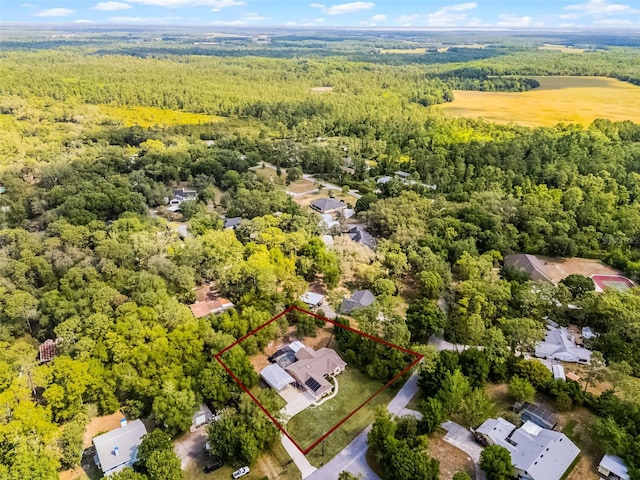 birds eye view of property with a wooded view