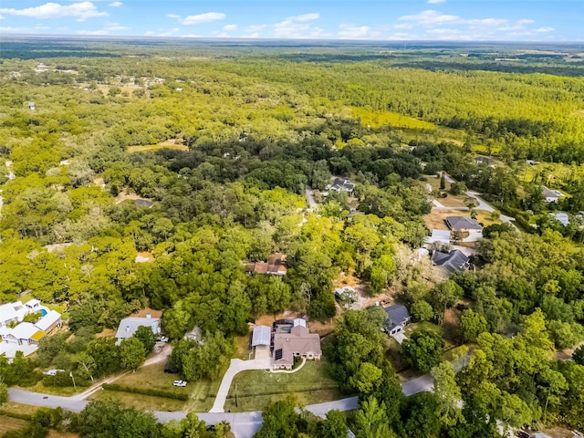 birds eye view of property featuring a wooded view