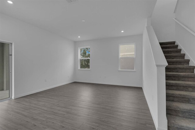 interior space with baseboards, dark wood-style floors, recessed lighting, and stairs