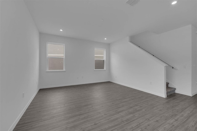 bonus room featuring stairs, dark wood finished floors, baseboards, visible vents, and recessed lighting