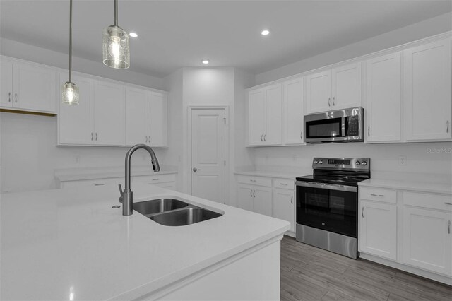 kitchen featuring white cabinets, recessed lighting, stainless steel appliances, and a sink