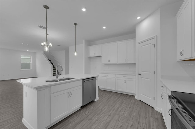 kitchen with stainless steel dishwasher, a sink, light wood finished floors, white cabinets, and recessed lighting