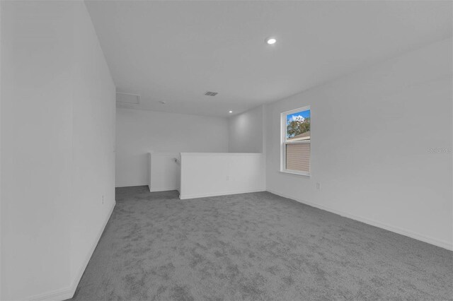 spare room featuring baseboards, carpet flooring, visible vents, and recessed lighting