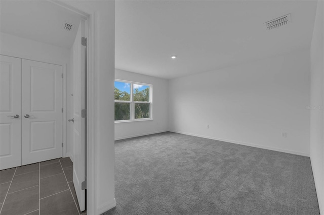 interior space with recessed lighting, dark carpet, visible vents, and baseboards