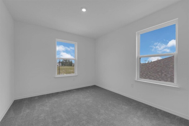 spare room featuring recessed lighting, carpet floors, and baseboards