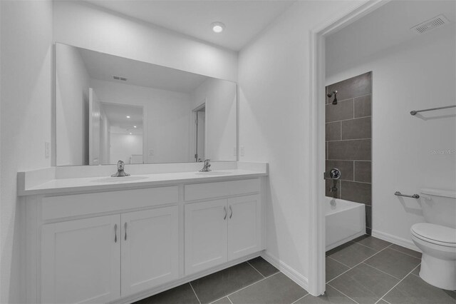 full bath with double vanity, visible vents, toilet, and a sink