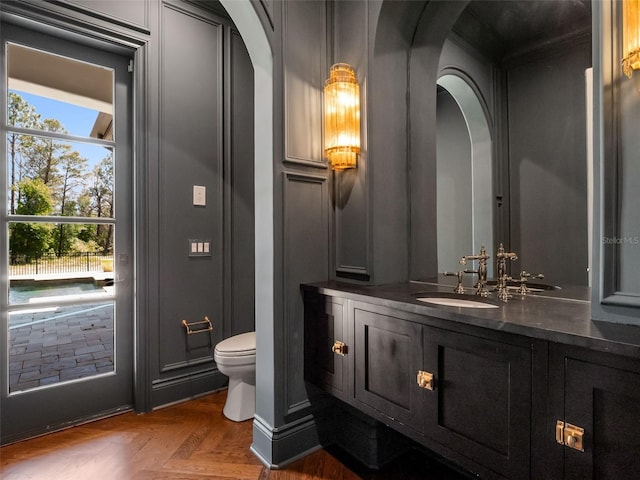 half bath featuring toilet and vanity