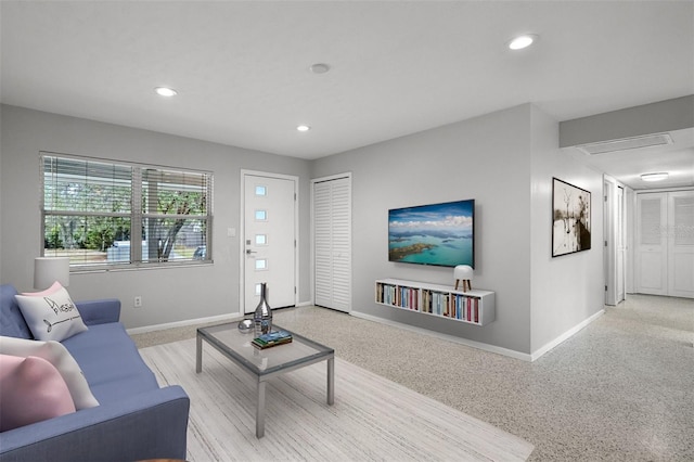 living room with recessed lighting and baseboards