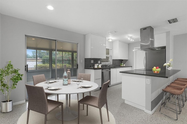 kitchen featuring light speckled floor, modern cabinets, island range hood, a sink, and dishwasher