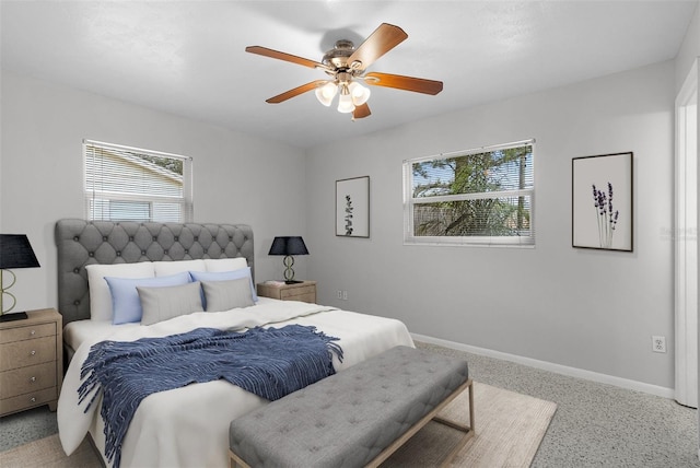 bedroom with baseboards, ceiling fan, and multiple windows