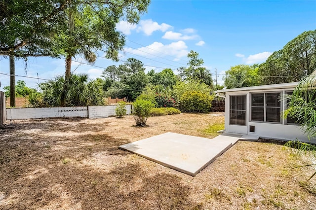 view of storm shelter with a fenced backyard, a yard, and a patio area