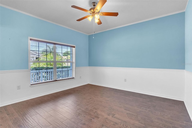 empty room with dark wood-type flooring, a ceiling fan, baseboards, and ornamental molding