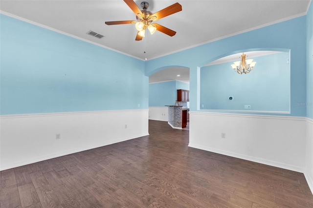 unfurnished room with arched walkways, ceiling fan with notable chandelier, dark wood finished floors, and visible vents