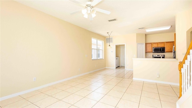 1204 Blackheath Ct, Davenport, FL 33897 - unfurnished living room featuring ceiling fan, light tile patterned flooring, and washer / dryer