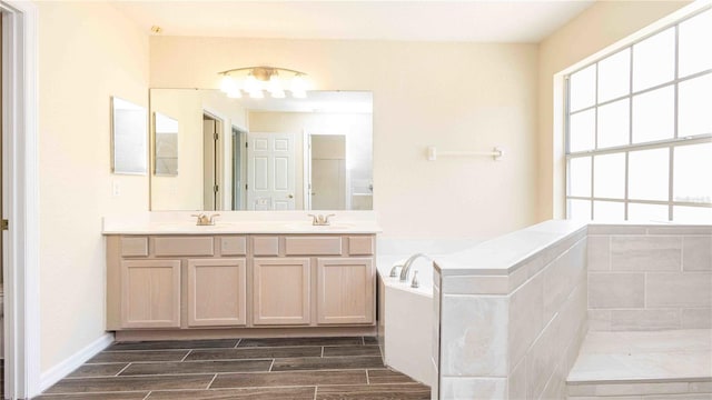 1204 Blackheath Ct, Davenport, FL 33897 - full bath with double vanity, plenty of natural light, a bath, and wood finish floors