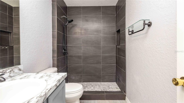 1204 Blackheath Ct, Davenport, FL 33897 - full bathroom featuring a textured wall, vanity, and a tile shower