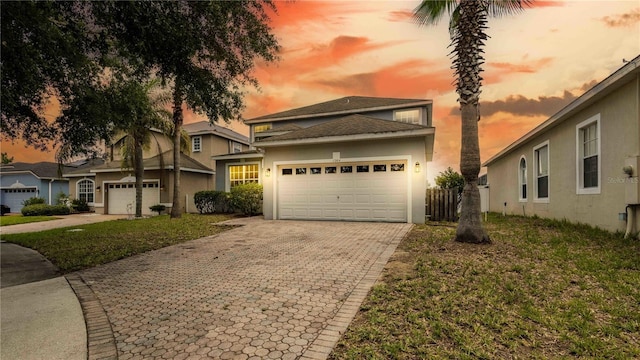 1204 Blackheath Ct, Davenport, FL 33897 - view of front of property with a garage, decorative driveway, and stucco siding