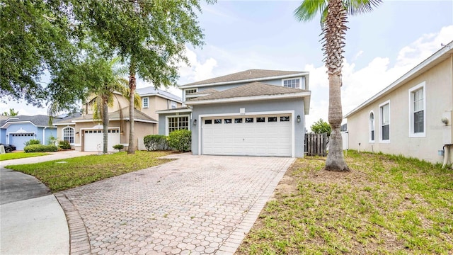 1204 Blackheath Ct, Davenport, FL 33897 - traditional-style house featuring a garage, decorative driveway, and stucco siding