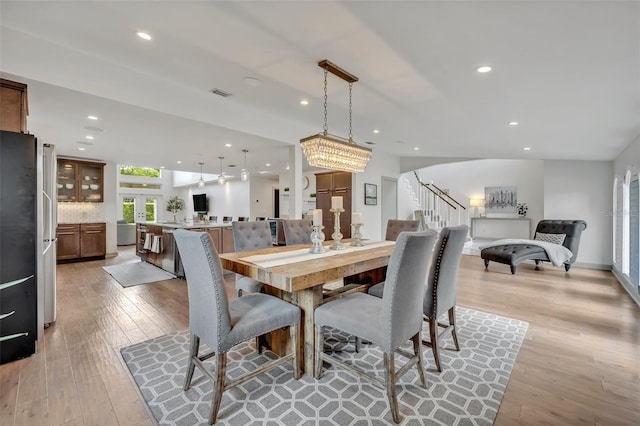 1661 Woodland Ave, Winter Park, FL 32789 - dining space with visible vents, light wood-style flooring, and stairway