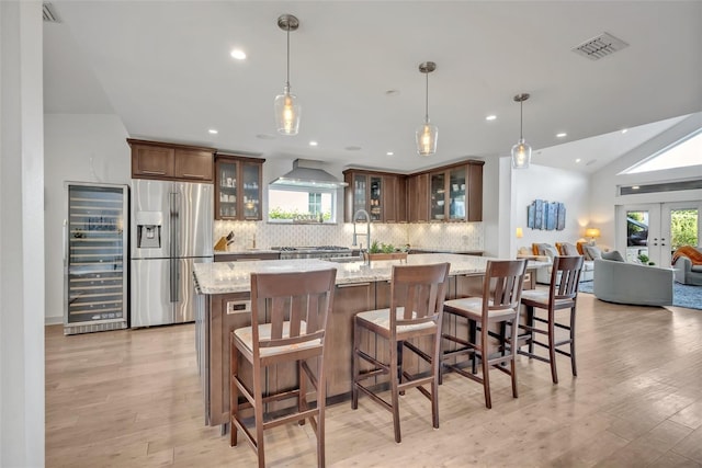 1661 Woodland Ave, Winter Park, FL 32789 - kitchen with visible vents, stainless steel fridge with ice dispenser, beverage cooler, tasteful backsplash, and a sink