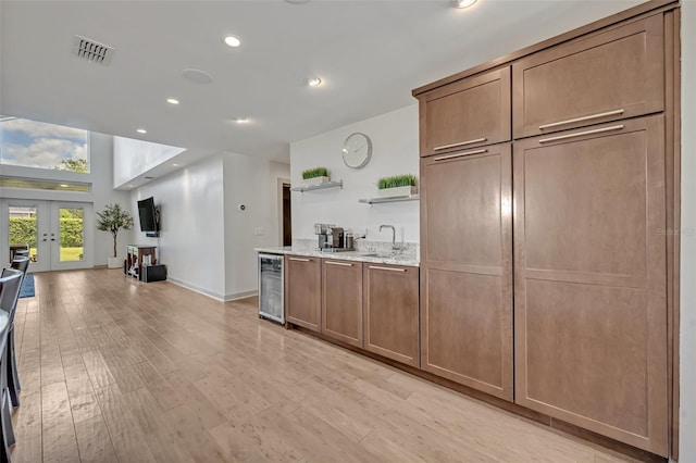 1661 Woodland Ave, Winter Park, FL 32789 - kitchen featuring visible vents, open shelves, beverage cooler, french doors, and a sink