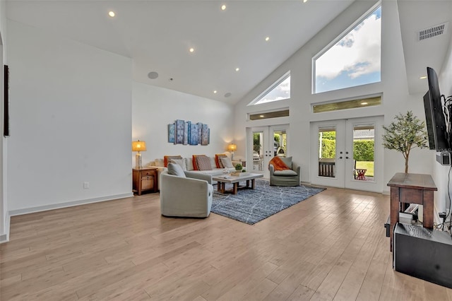 1661 Woodland Ave, Winter Park, FL 32789 - living area with high vaulted ceiling, visible vents, french doors, and light wood-type flooring