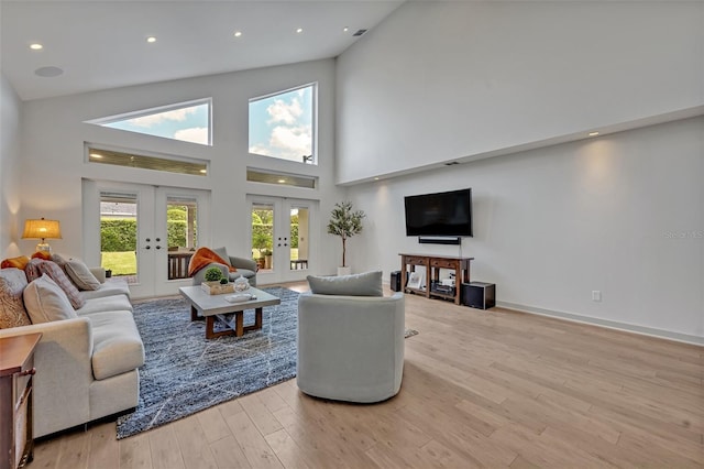 1661 Woodland Ave, Winter Park, FL 32789 - living area featuring wood finished floors, baseboards, high vaulted ceiling, recessed lighting, and french doors