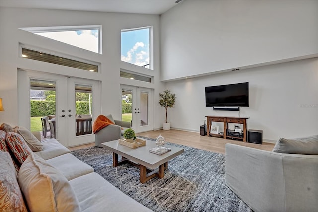 1661 Woodland Ave, Winter Park, FL 32789 - living room featuring baseboards, french doors, wood finished floors, and a towering ceiling
