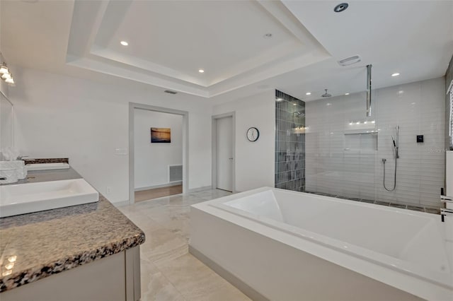 1661 Woodland Ave, Winter Park, FL 32789 - bathroom featuring double vanity, a tile shower, a sink, a raised ceiling, and recessed lighting