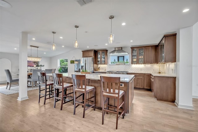 1661 Woodland Ave, Winter Park, FL 32789 - kitchen with stainless steel fridge with ice dispenser, decorative backsplash, light wood-type flooring, and visible vents