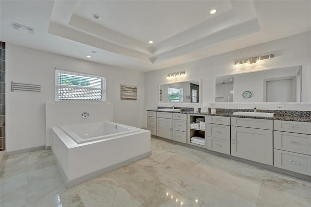 1661 Woodland Ave, Winter Park, FL 32789 - full bath featuring a sink, a raised ceiling, a bath, and two vanities