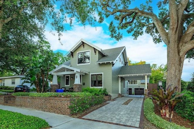 view of front of home with a shingled roof and driveway