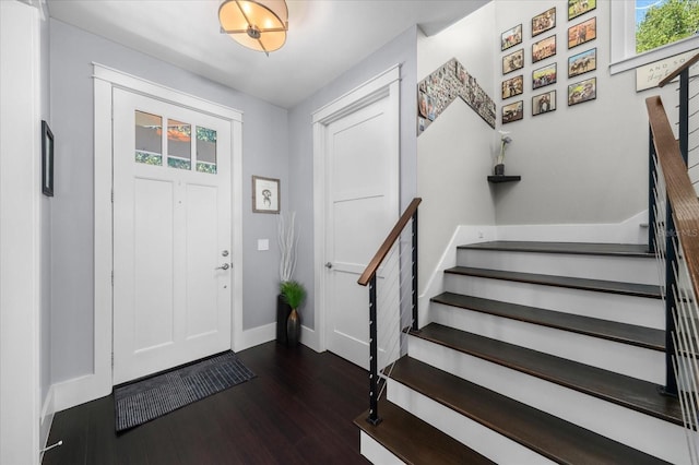 entryway featuring baseboards, stairway, and dark wood-style flooring