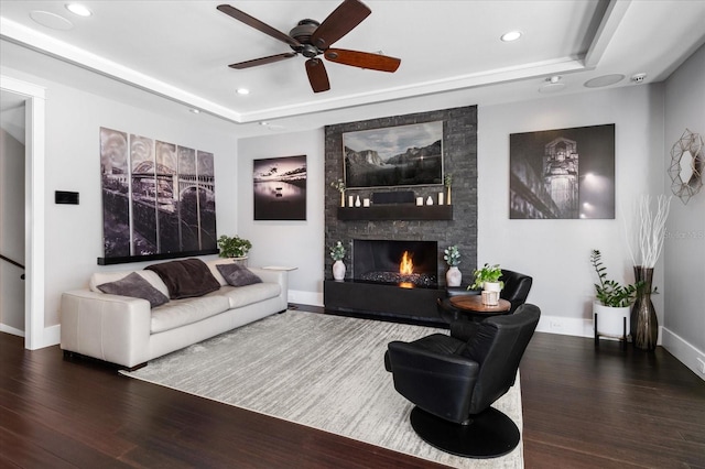 living room featuring ceiling fan, recessed lighting, wood finished floors, and a raised ceiling