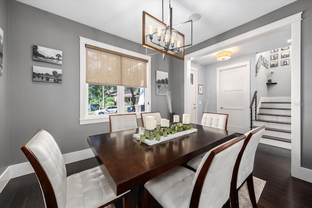 dining space featuring stairway, baseboards, wood finished floors, and a chandelier