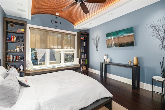 bedroom featuring lofted ceiling, baseboards, and wood-type flooring