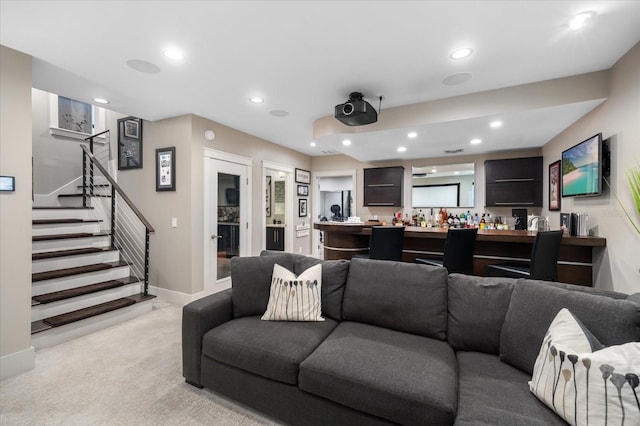 living room with recessed lighting, stairway, baseboards, light colored carpet, and bar