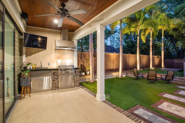 view of patio with an outdoor kitchen, a sink, a fenced backyard, ceiling fan, and grilling area