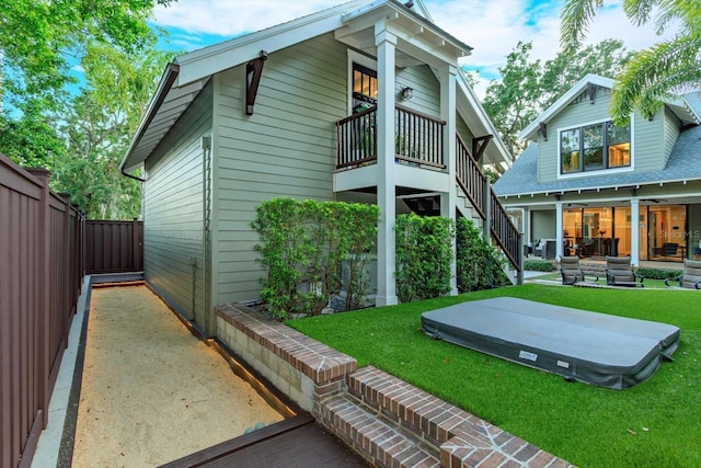 rear view of property featuring stairs, a yard, a patio, and a fenced backyard