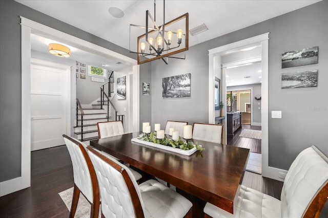 dining area with stairway, dark wood finished floors, a wealth of natural light, and a chandelier