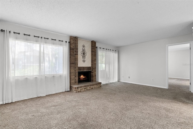 11 Escondido Cir Unit 110, Altamonte Springs, FL 32701 - unfurnished living room with a textured ceiling, carpet flooring, and a fireplace