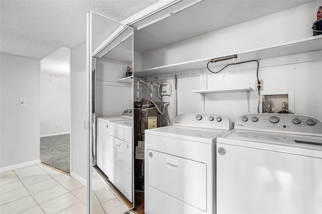 11 Escondido Cir Unit 110, Altamonte Springs, FL 32701 - laundry room with washer and clothes dryer, a textured ceiling, and light tile patterned floors