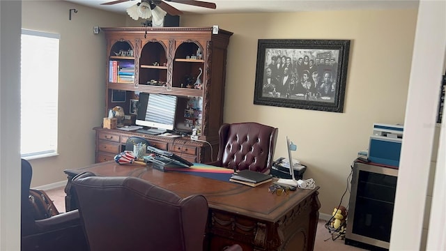 office featuring carpet floors, baseboards, and ceiling fan