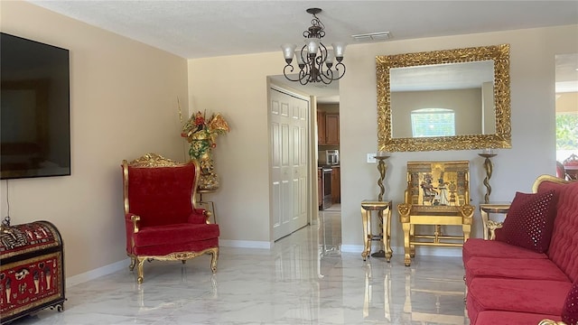 living area featuring marble finish floor, baseboards, a chandelier, and visible vents